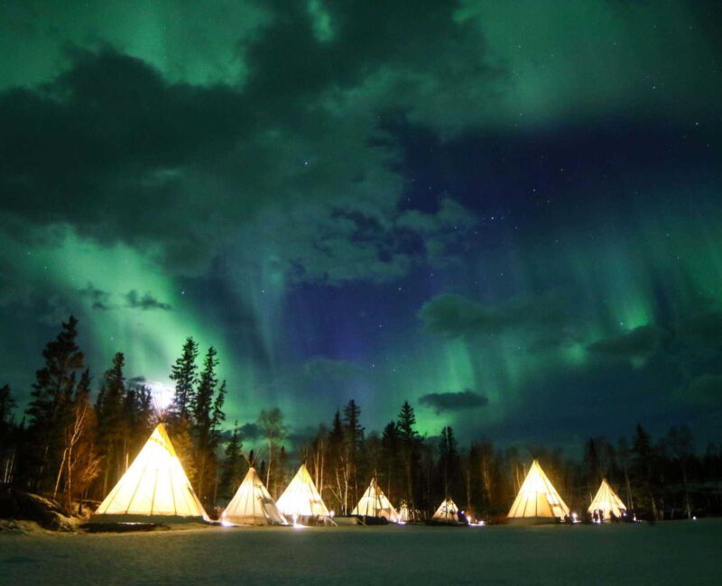 Aurora-Village-Yellowknife-Northwest-Territories-Canada-Aurora-Borealis-Northern-Lights-teepees-winter-hero-cloud